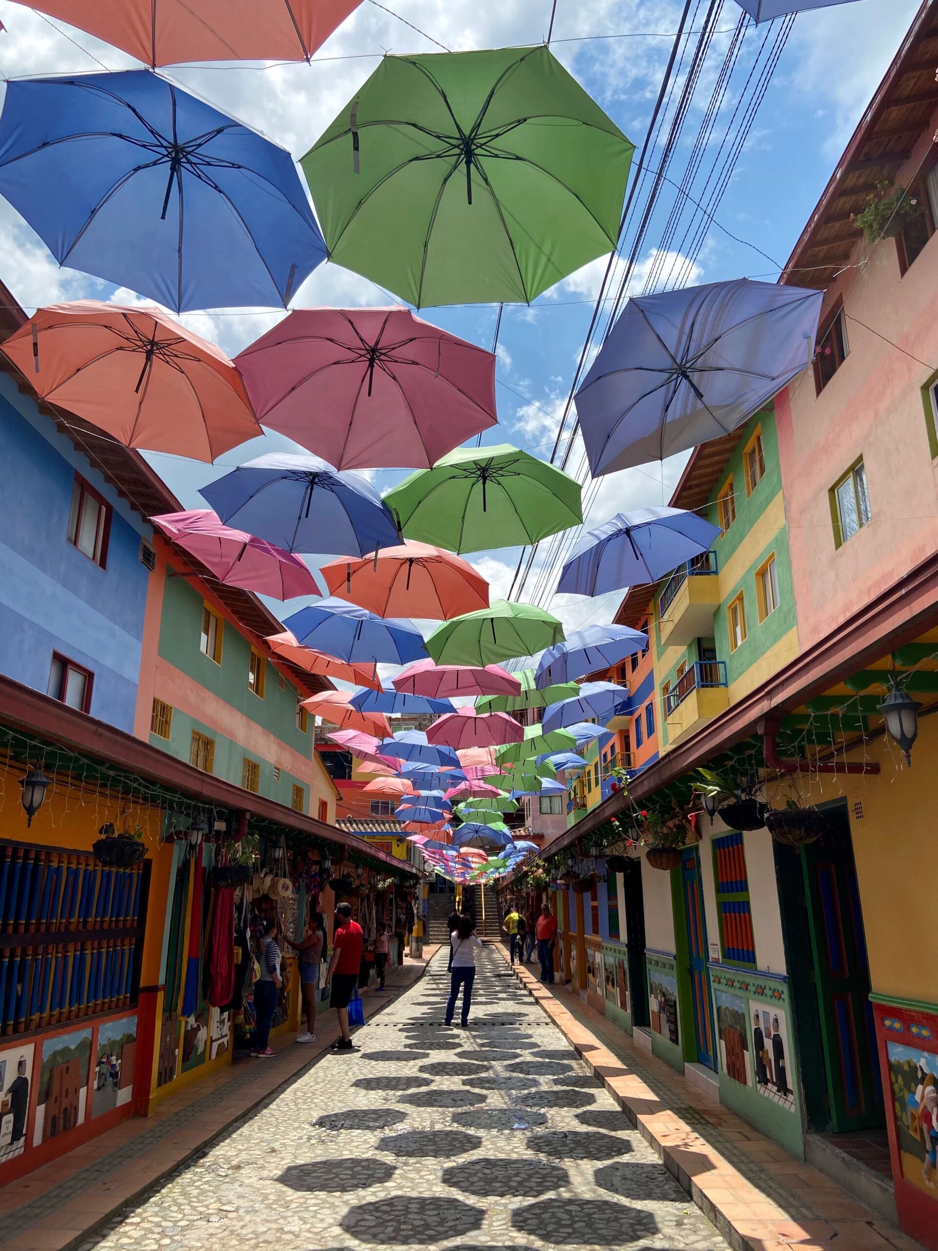 Colourful umbrellas hanging above the street leading to Plazoleta de Los Zócalos