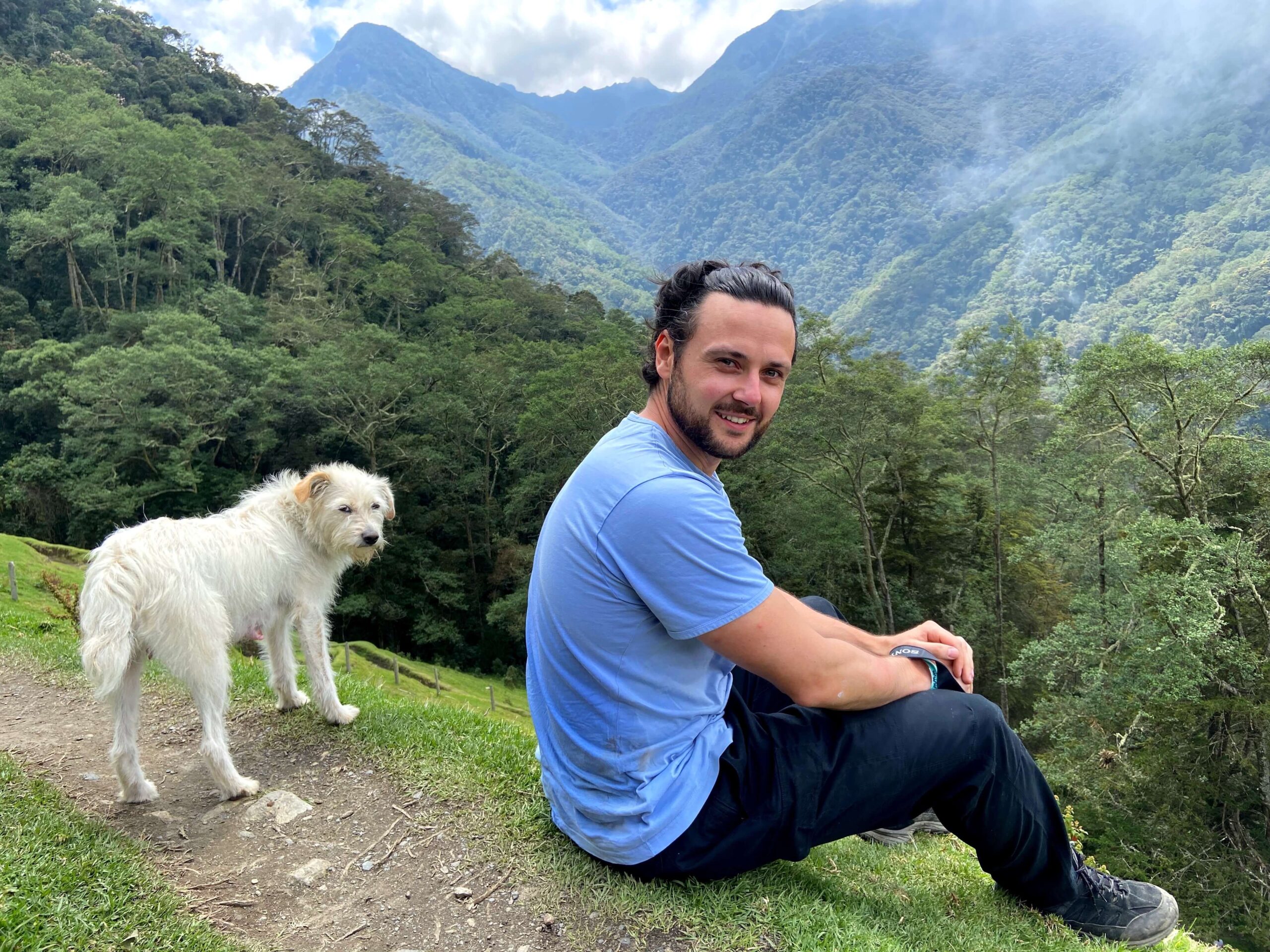 Alex & local farm dog with the jungle mountainsides behind.