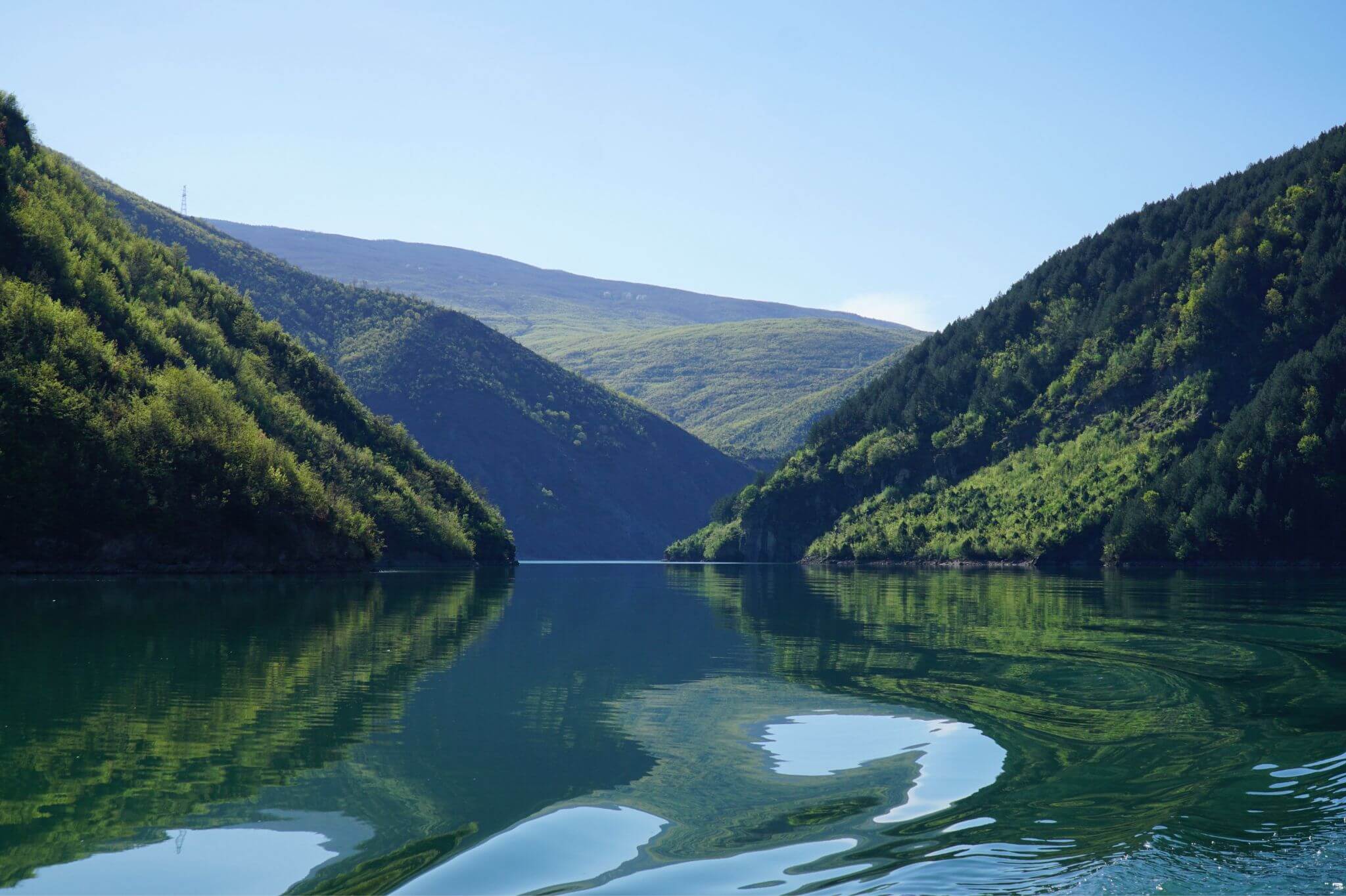 Mountain reflection on Lake Komani